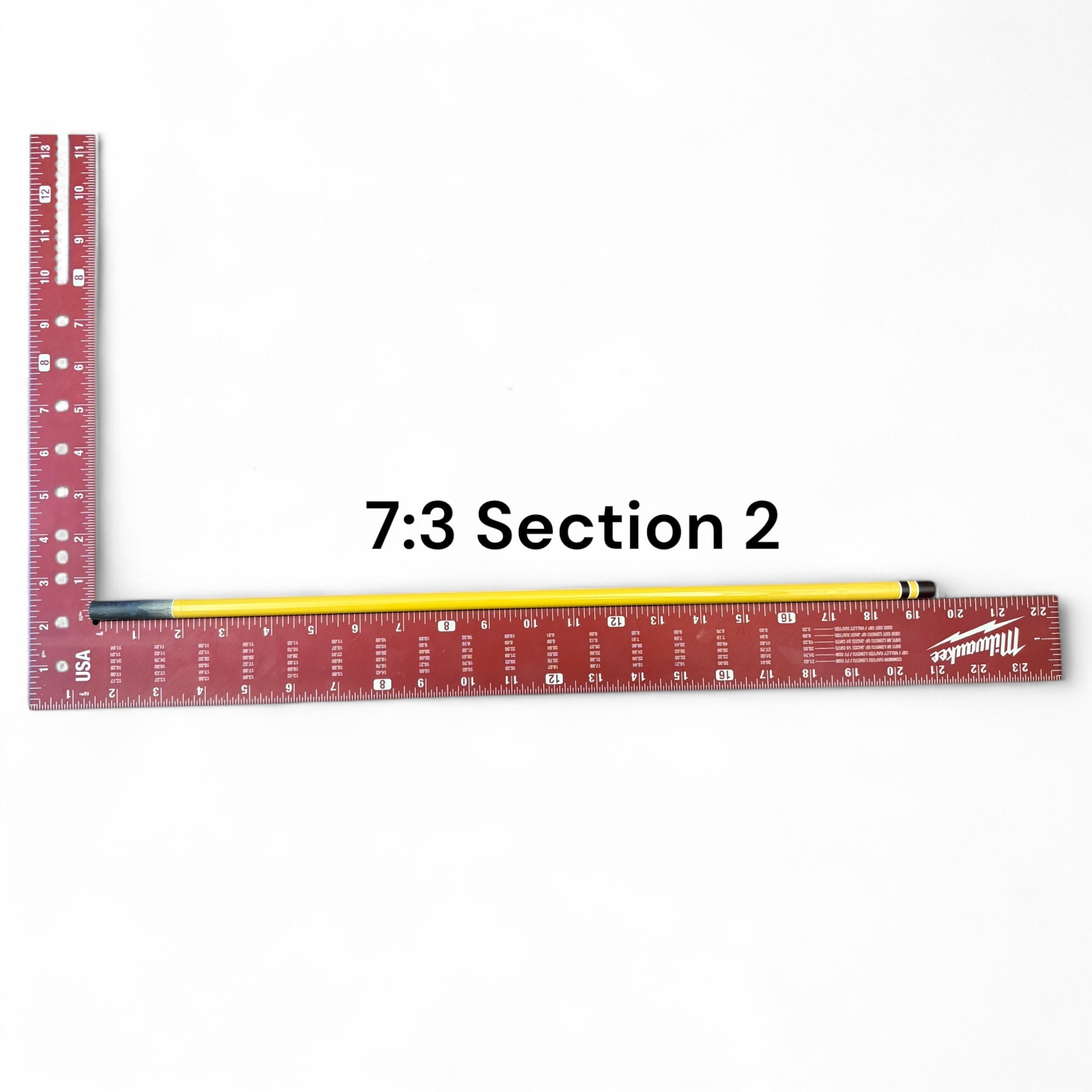 Section 2 of the Middle Fork 7:3 Tenkara Rod by Wasatch Tenkara Rods, displayed with a red measuring square for scale. The rod features yellow carbon fiber construction with brown accent bands.