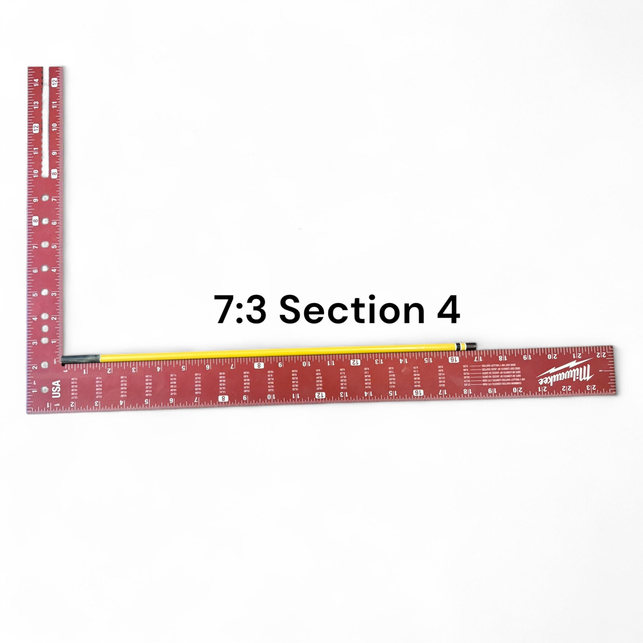 Section 4 of the Middle Fork 7:3 Tenkara Rod by Wasatch Tenkara Rods, displayed with a red measuring square for scale. The rod features yellow carbon fiber construction with brown accent bands.