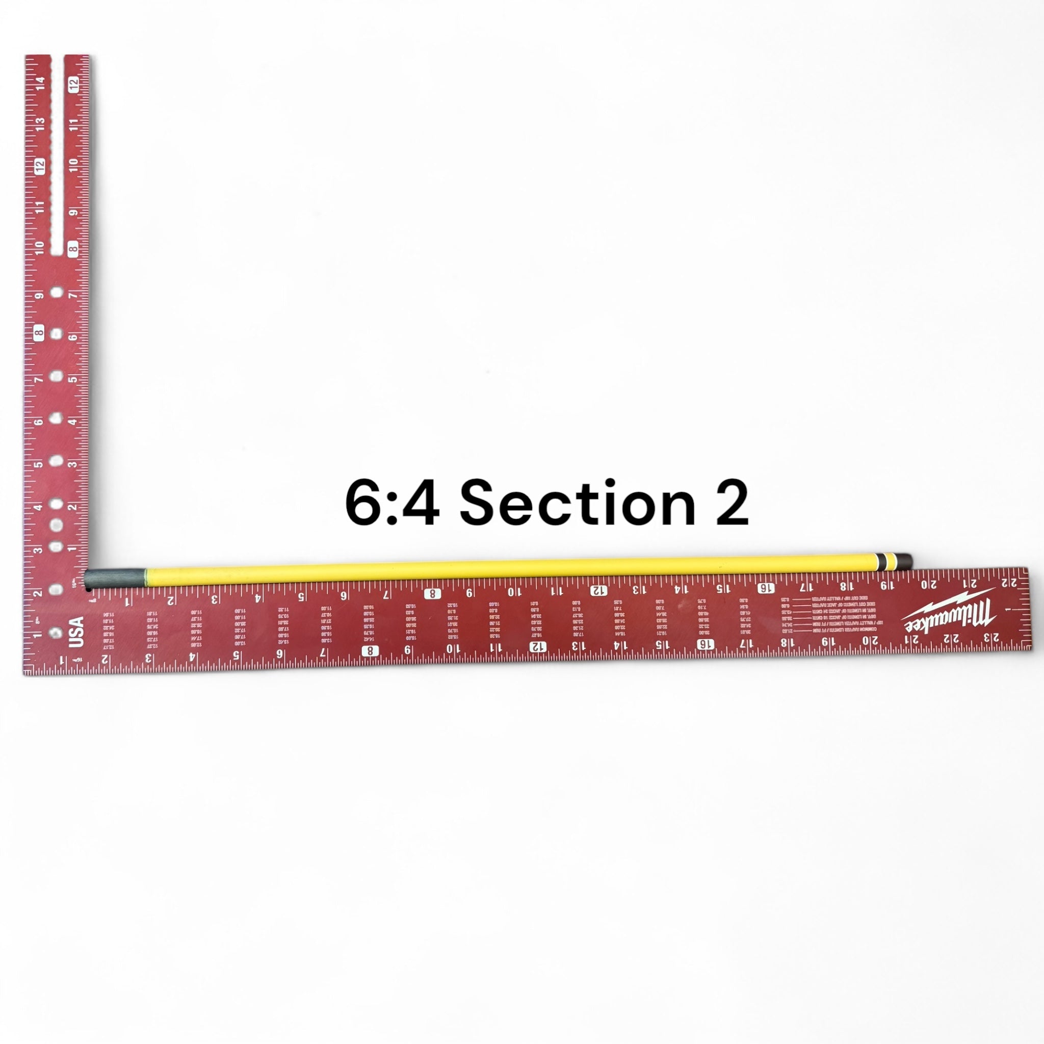 Section 2 of the Middle Fork 6:4 Tenkara Rod by Wasatch Tenkara Rods, displayed alongside a red measuring square for scale. The section features the rod’s yellow carbon fiber finish with brown accent bands.