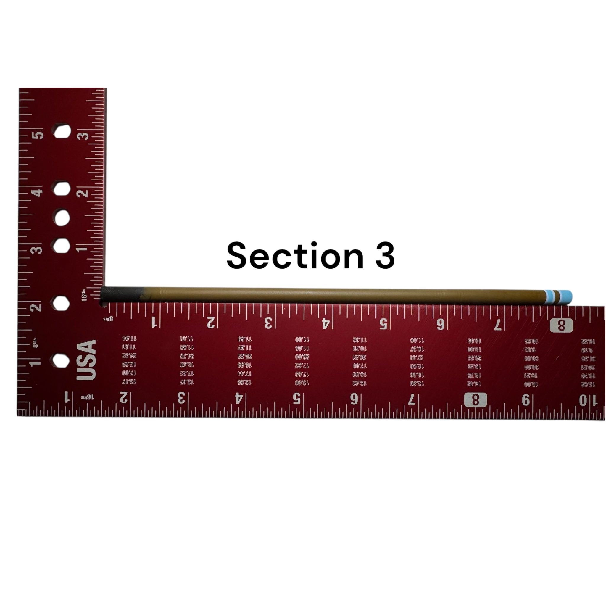 Section 3 of the Wasatch Tenkara Rods Snub Nose IV placed against a red measuring square for size reference, showing custom color banding and precision fit design for modular rod construction.