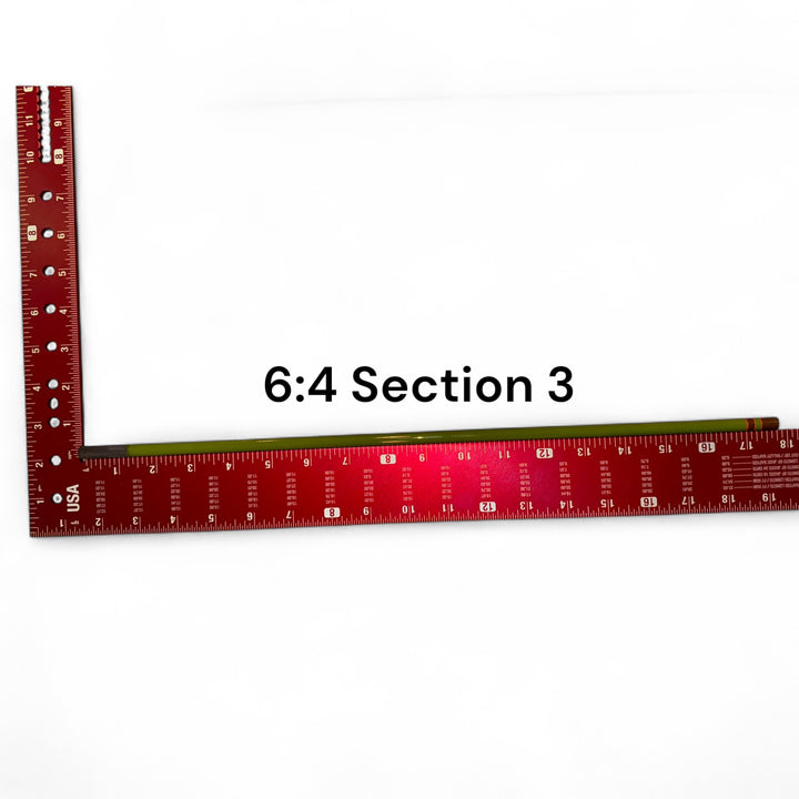 Wasatch Tenkara Rods Baby RodZilla 6:4 Section 3 replacement part shown against a measuring square for scale—green carbon fiber rod segment for ultralight tenkara fly fishing rod repair.