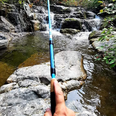 The Maruki Sharpshooter Tenkara rod with a customer fishing a tiny stream!
